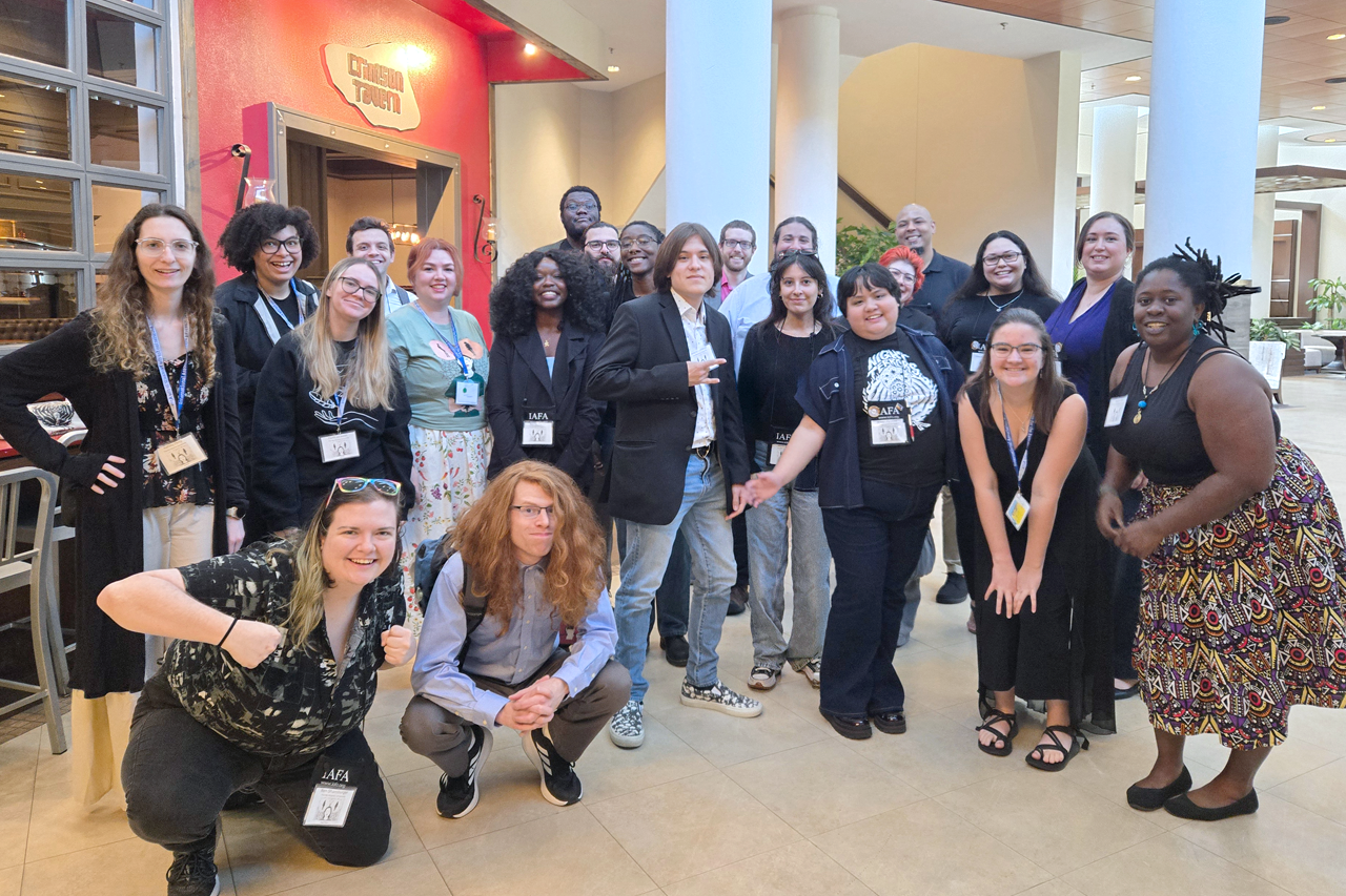 A group of students and faculty smiling at the International Conference on the Fantastic in the Arts (IFCA)