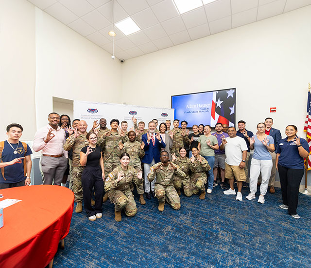 Group of military and veteran students with president Hasner