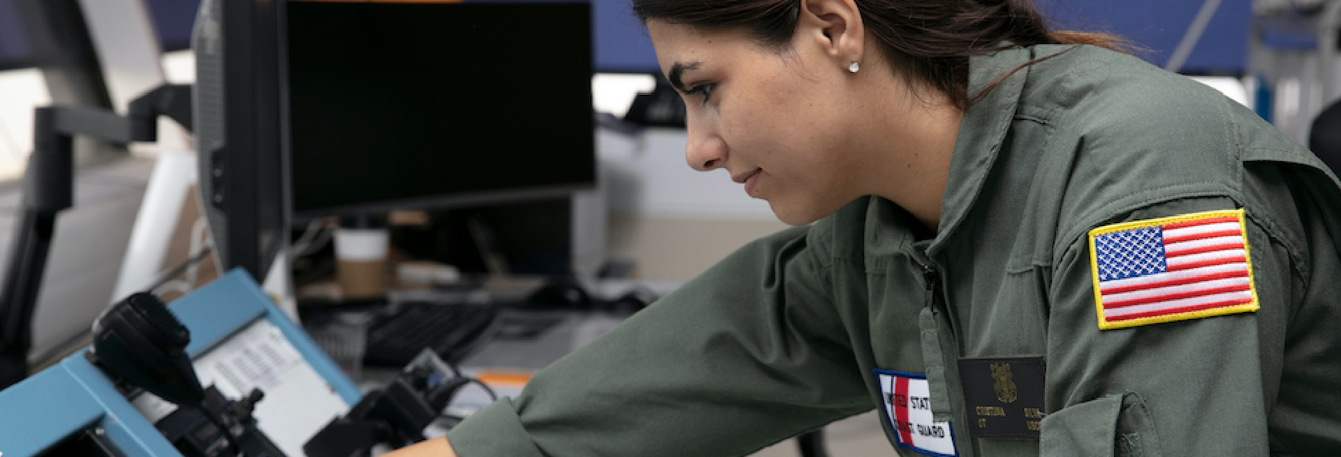 Female soldier in front of helicopter