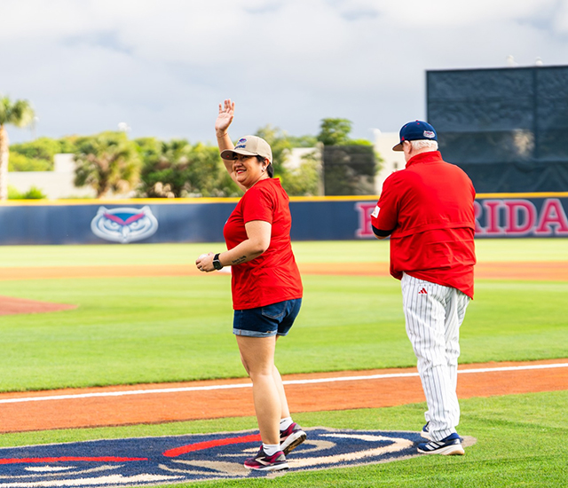 U.S. Marine Corps Veteran and FAU graduate student throws the ceremonial first pitch at the FAU Baseball Florida Atlantic grad walking to the mound to throw first pitch