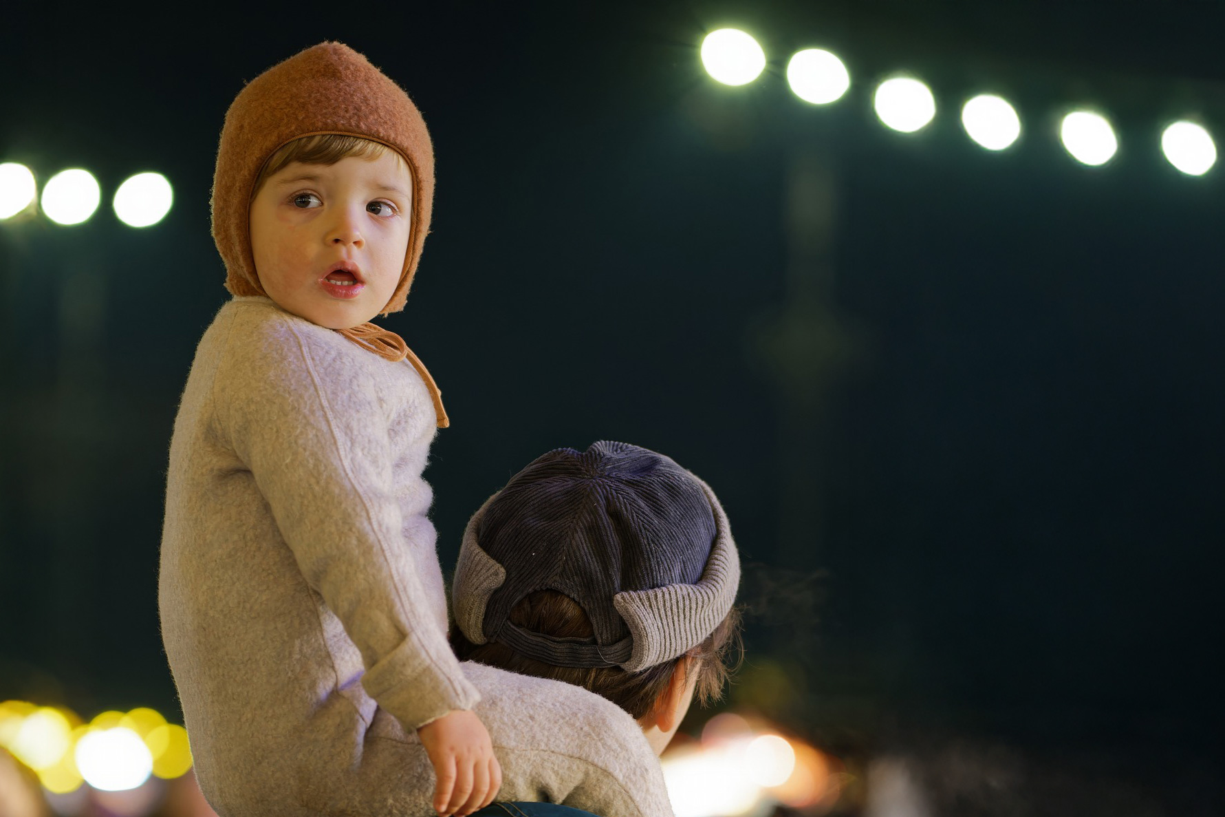 child on father's shoulders