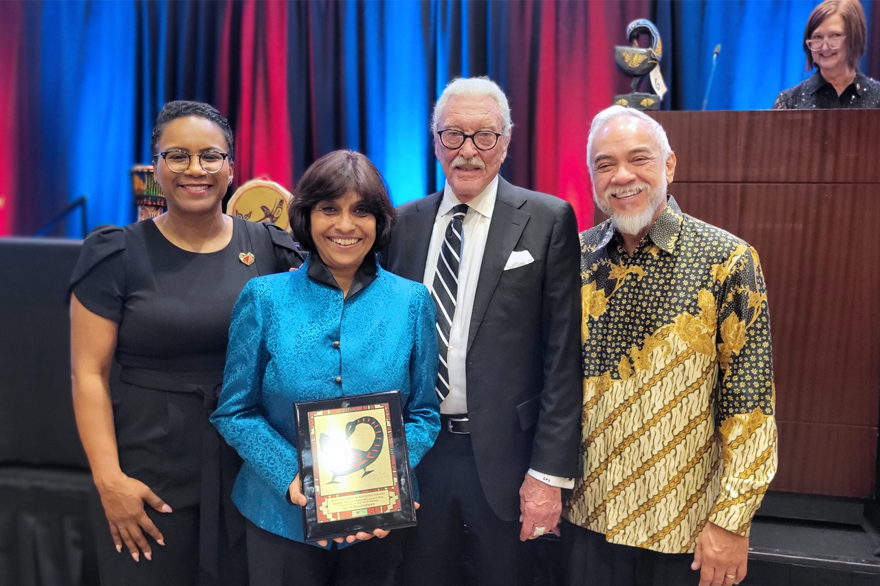 Dilys Schoorman with NAME award flanked by Lakia Scott (President-Elect, NAME), G. Prtichy Smith (NAME Founder and Award Donor), and Ludy van Broekhuizen.  