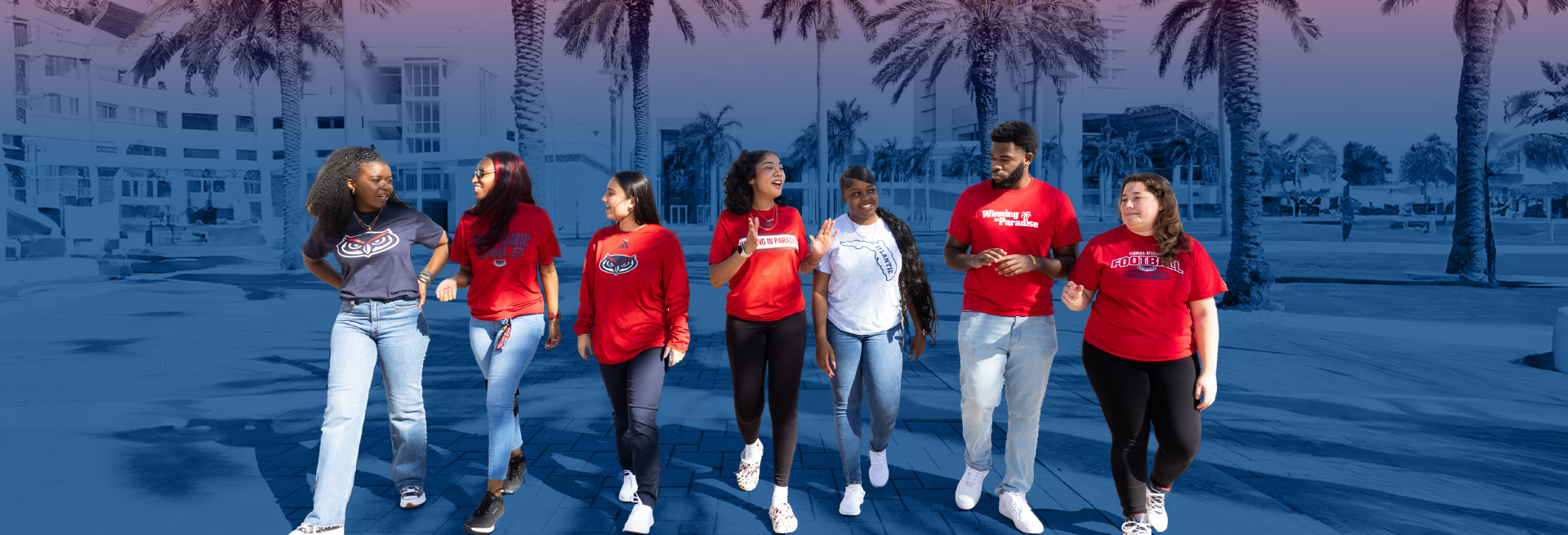 Red and Blue Weeks - A group of students wearing red Florida Atlantic t-shirts while strolling on campus