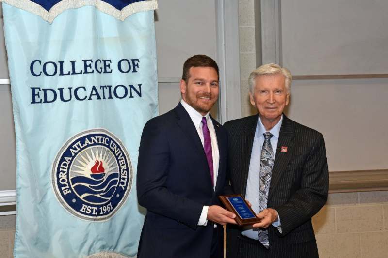 From right to left, Dr. Robert Shockley, Ph.D., Chair and Professor, presents the 2024 COE Outstanding Graduate Student Award to Daniel Cornely.
