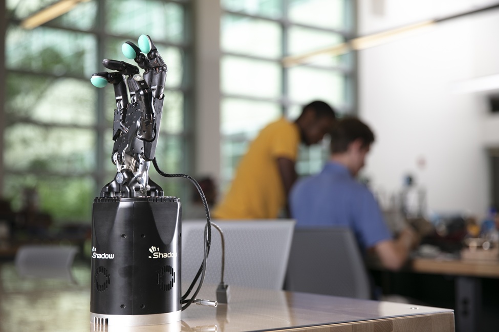 The trained AI model converts the user’s forearm muscle movements into real-time commands that control a robotic hand, allowing it to perform the intended gestures. (Photo by Alex Dolce)