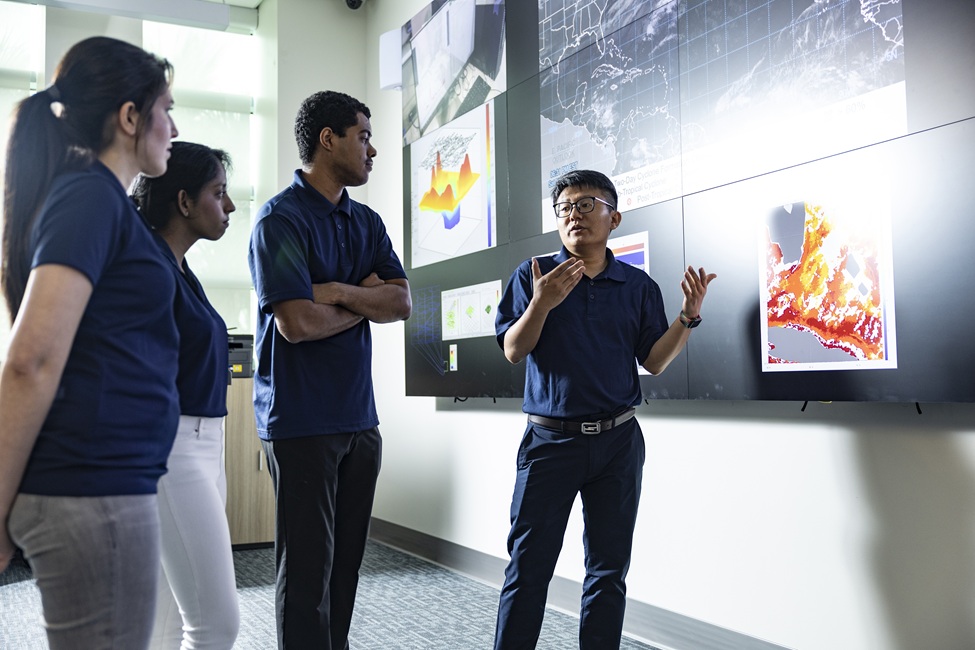 Yufei Tang, Ph.D., on the right, principal investigator and associate professor in FAU’s Department of Electrical Engineering and Computer Science, director of the FPL Center for Intelligent Energy Technologies (InETech), and faculty fellow of FAU’s Institute for Smarter Cities, Spaces, and Health.