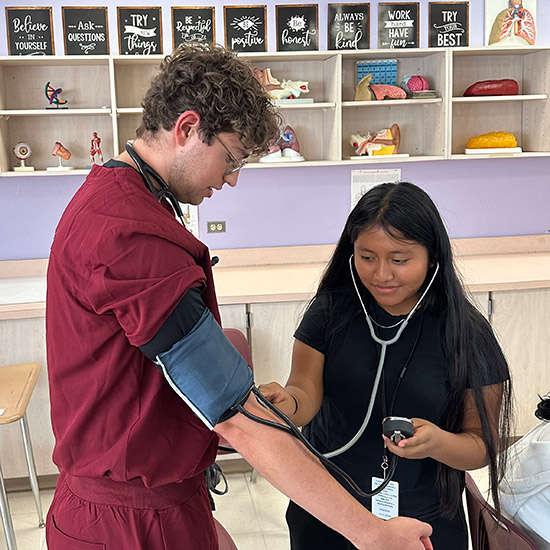 High school students practicing with stethoscope