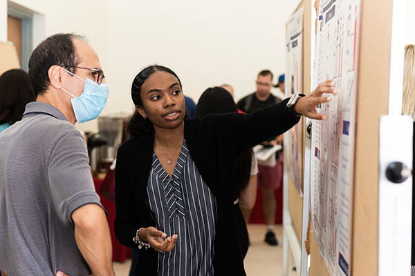 Graduate student showcasing research