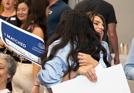 FAU Schmidt College of Medicine Match Day 2024 MD students celebrating and hugging after announcement