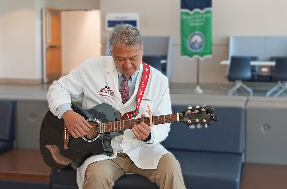 Dr. Richard Shih playing the guitar