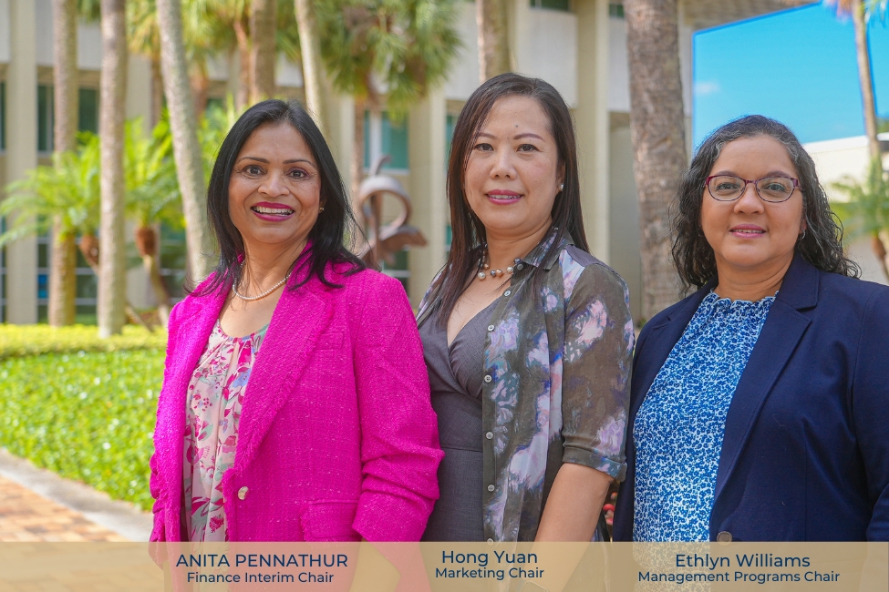 A photo of the three new deans of the School of Business standing outside the building. 