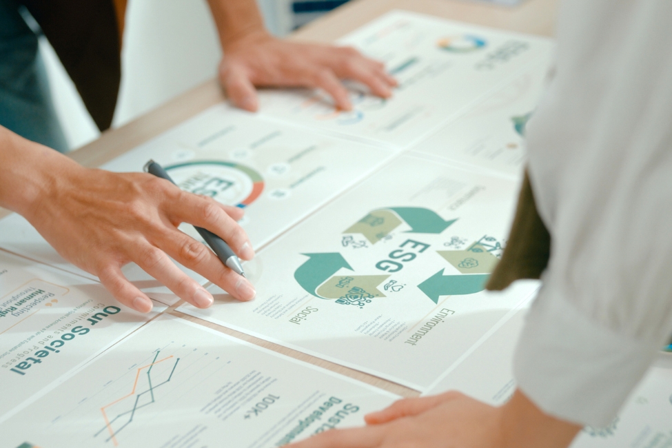 A close up of two people examining an ESG chart