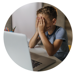 child at computer with hands over face