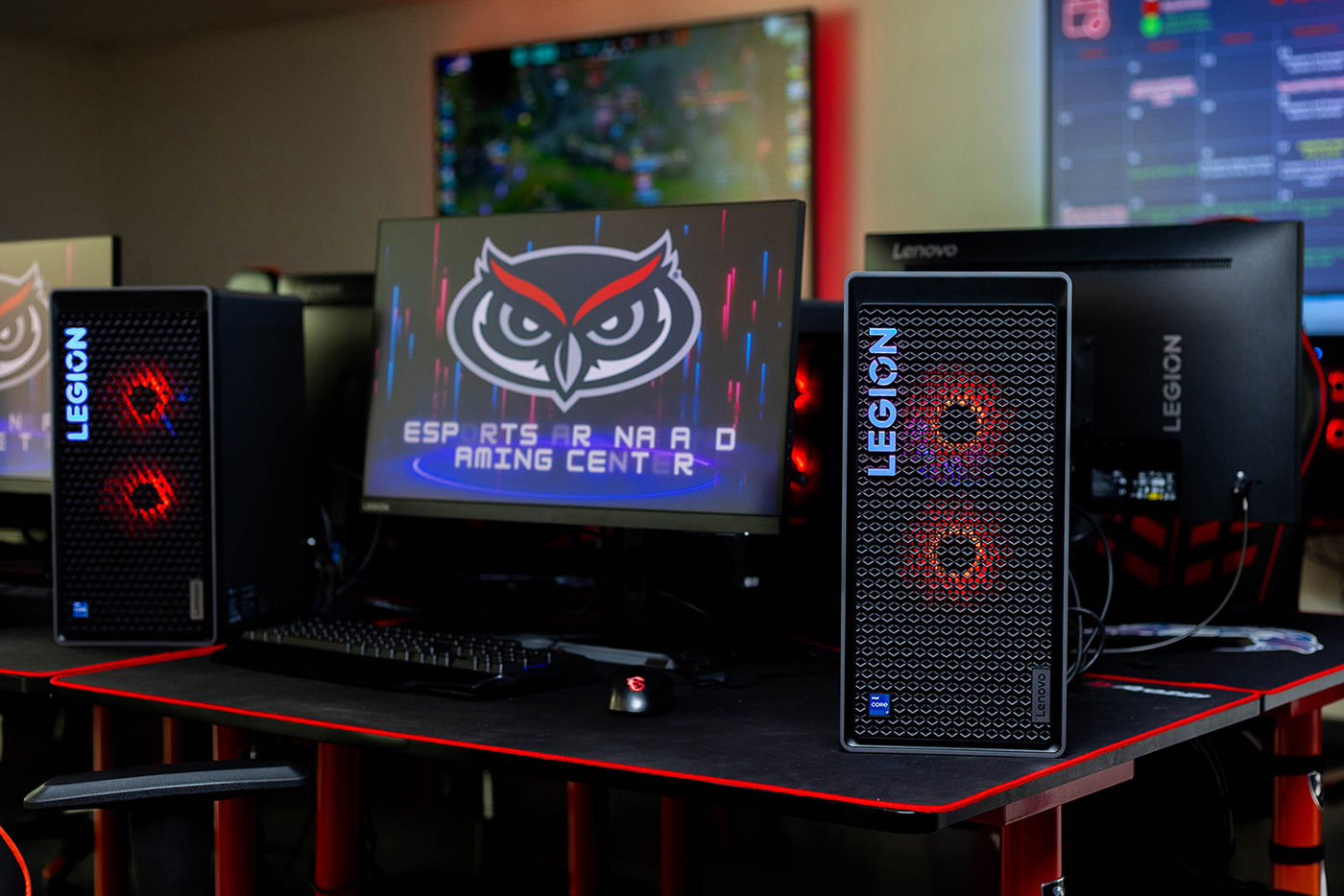 a Lenovo Legion gaming computer with a black and red theme and the Owl Head logo shown on the screen